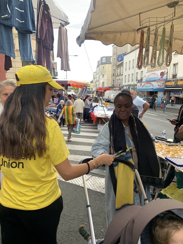 Animatrice Western Union en distribution sur un marché à Montreuil